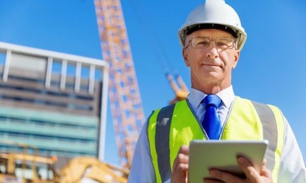depositphotos_105184220-stock-photo-engineer-builder-at-construction-site-e1595965626392.jpg